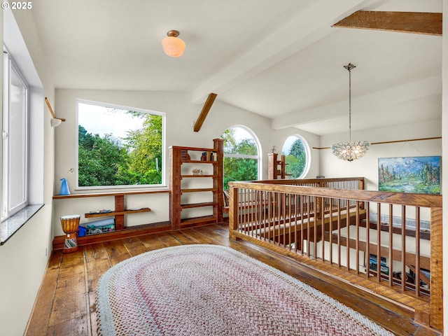 interior space featuring vaulted ceiling with beams, a notable chandelier, and hardwood / wood-style flooring
