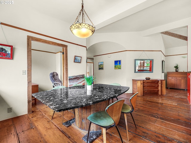 dining space featuring vaulted ceiling and hardwood / wood-style flooring