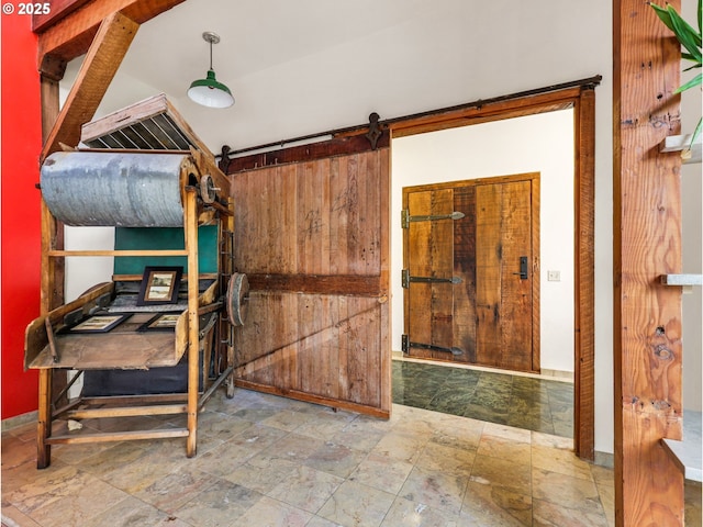 unfurnished bedroom featuring stone finish floor and baseboards