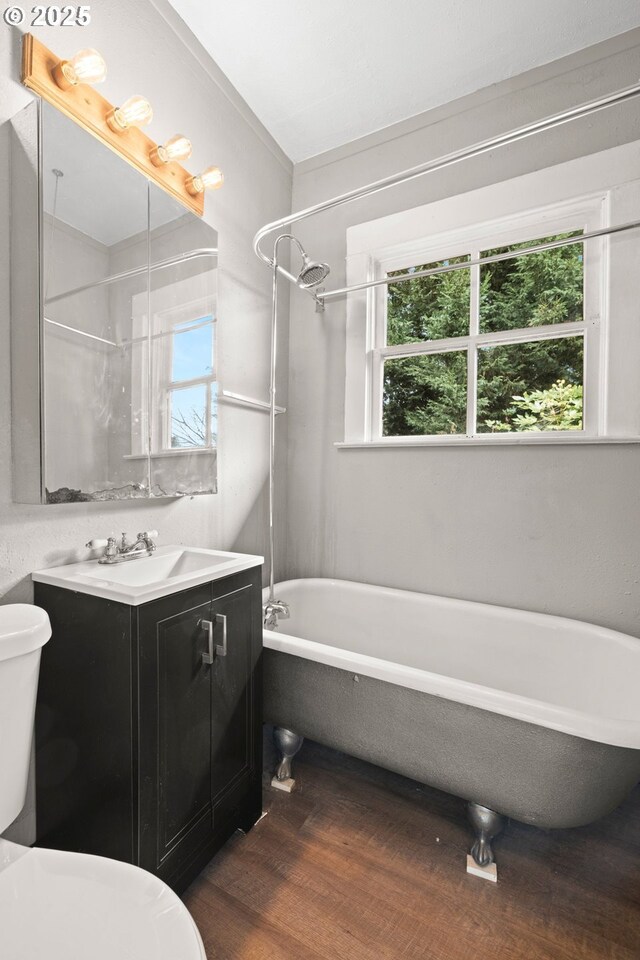 full bathroom with vanity, wood-type flooring, shower / washtub combination, and toilet