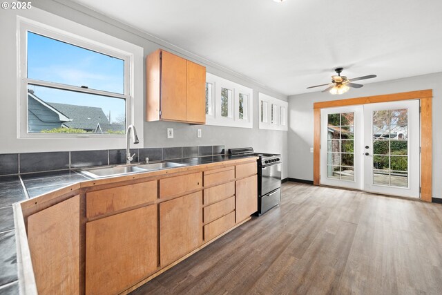 kitchen with sink, ceiling fan, light hardwood / wood-style floors, black stove, and french doors