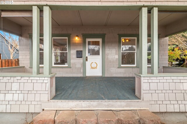 doorway to property featuring a porch