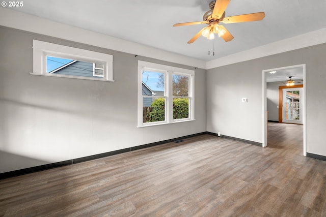 unfurnished room with hardwood / wood-style flooring