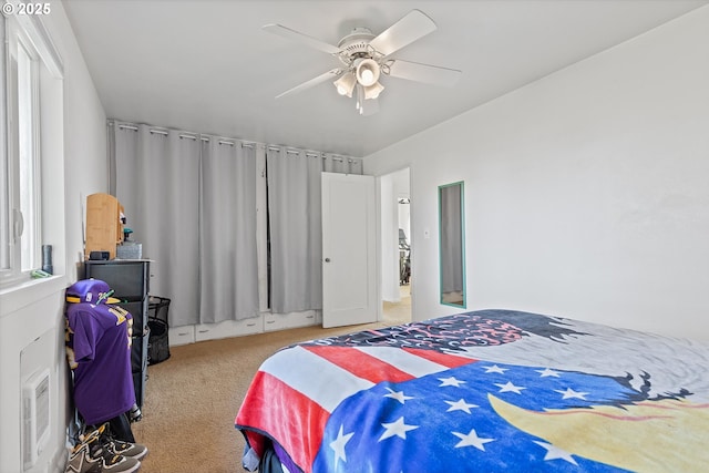 carpeted bedroom featuring ceiling fan