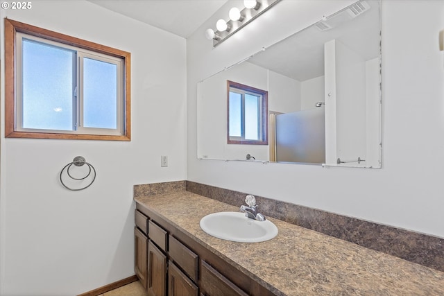 bathroom with vanity and a shower