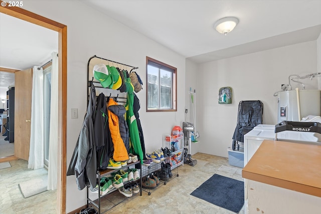 interior space with water heater and washing machine and dryer