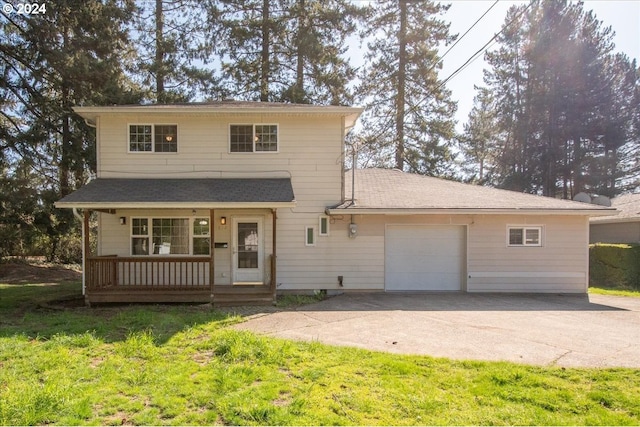 front facade with a porch, a front yard, and a garage