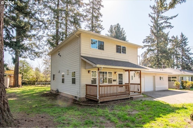 view of front of home with a front yard, a garage, and a porch