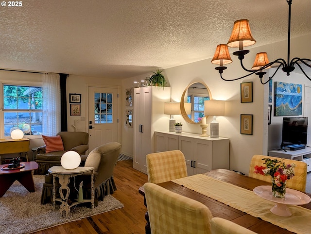 695 NW Towle Ave, Gresham, OR 97030 - dining area featuring a textured ceiling, wood finished floors, and a chandelier