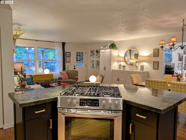695 NW Towle Ave, Gresham, OR 97030 - kitchen featuring gas range, open floor plan, a textured ceiling, a chandelier, and wood finished floors