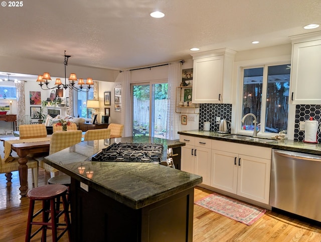 695 NW Towle Ave, Gresham, OR 97030 - kitchen featuring dishwasher, backsplash, light wood-style floors, a kitchen island, and recessed lighting