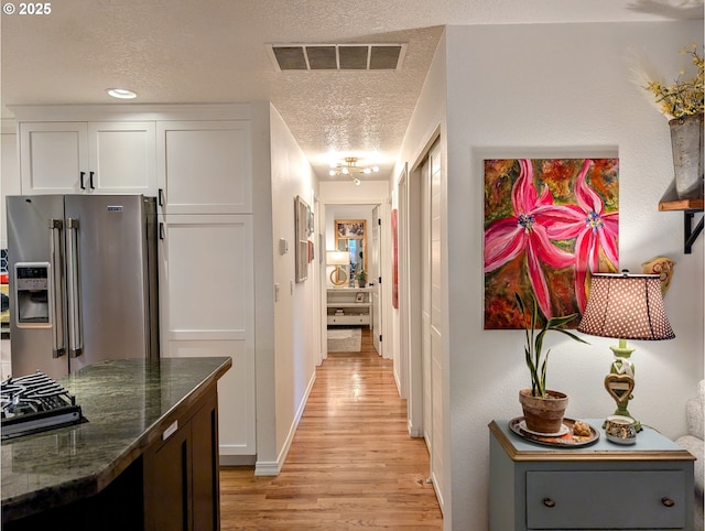 695 NW Towle Ave, Gresham, OR 97030 - corridor featuring light wood-type flooring and a textured ceiling