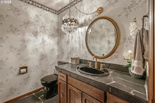 half bath with toilet, wallpapered walls, baseboards, and vanity