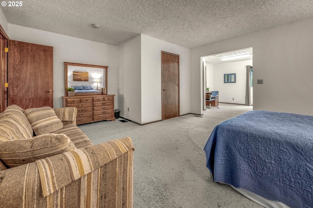 bedroom featuring light carpet and a textured ceiling