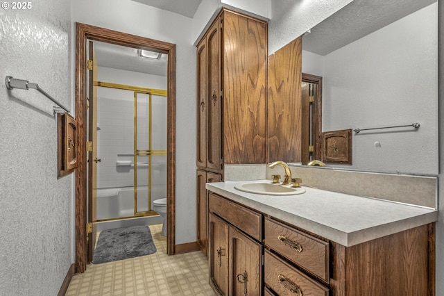 full bathroom with a textured wall, toilet, vanity, tile patterned floors, and a stall shower