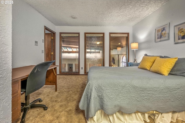 bedroom featuring a textured wall, carpet floors, and a textured ceiling