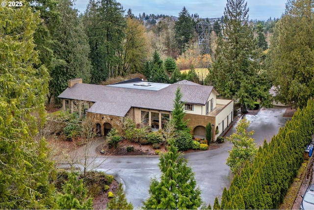 drone / aerial view featuring a wooded view