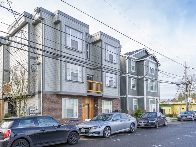 townhome / multi-family property with brick siding