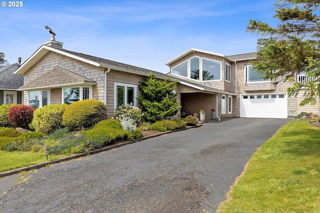 825 1st St, Otter Rock, OR 97369 - view of front of house with driveway, a garage, roof with shingles, and a chimney