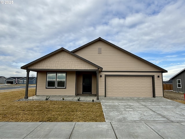 view of front of house featuring a front yard and a garage