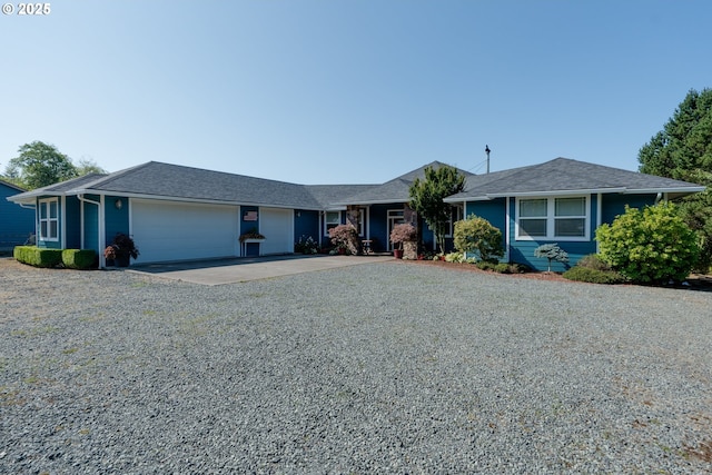 ranch-style house featuring a garage and driveway