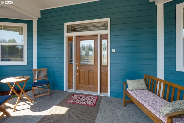 view of exterior entry featuring covered porch