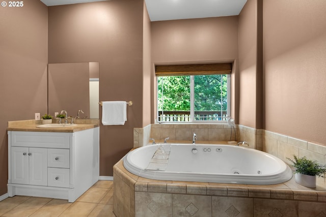 bathroom with vanity, a tub with jets, and tile patterned floors