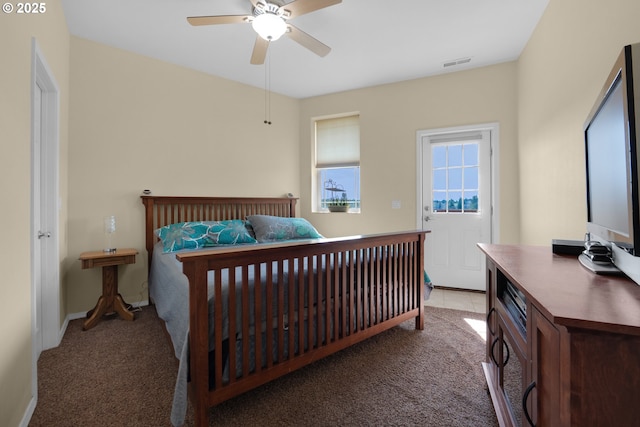 carpeted bedroom with a ceiling fan, visible vents, and baseboards