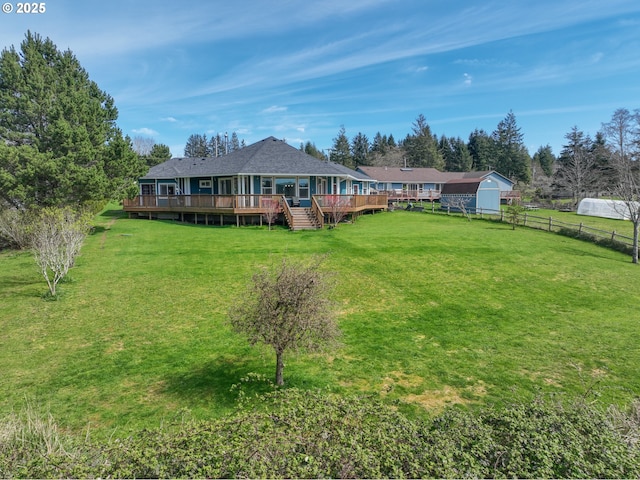 view of yard featuring fence and a deck