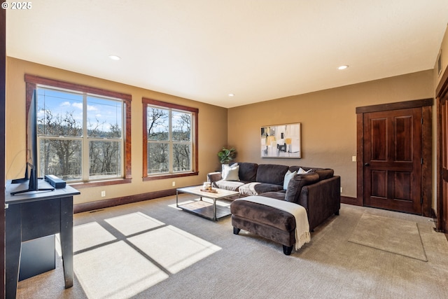 living room featuring baseboards, recessed lighting, and light colored carpet