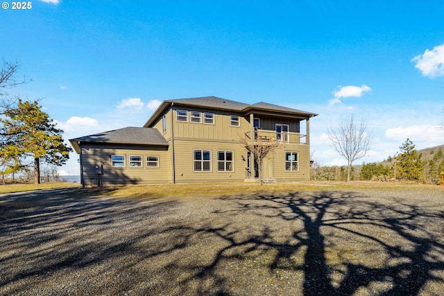 back of property with a balcony