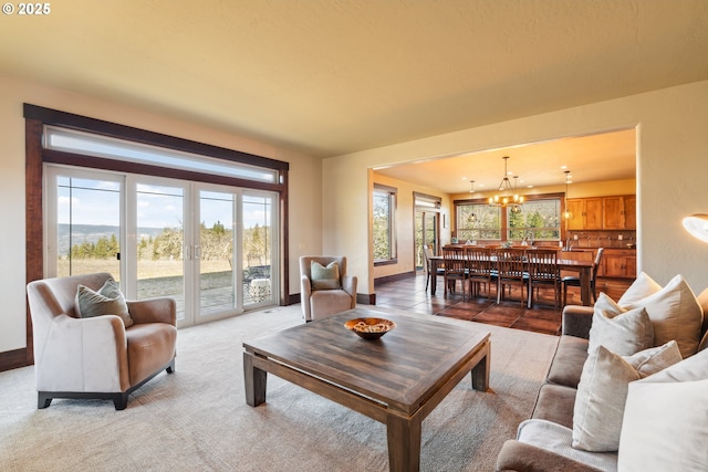 living room with baseboards, french doors, and an inviting chandelier