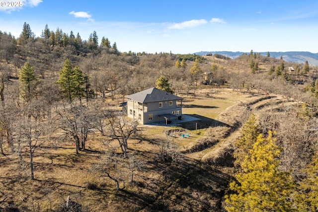 bird's eye view with a wooded view