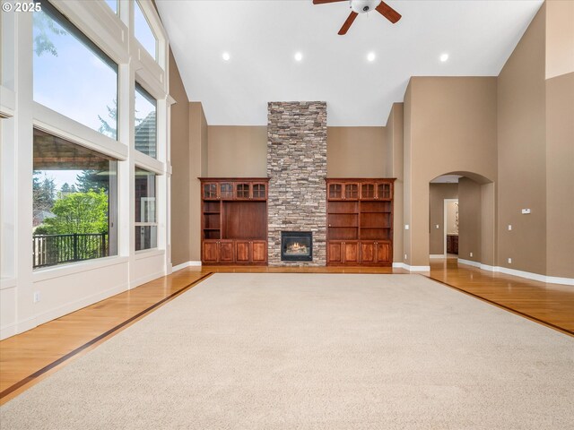1303 NE 147th Ave, Vancouver, WA 98684 - unfurnished living room with high vaulted ceiling, ceiling fan, plenty of natural light, arched walkways, and a stone fireplace