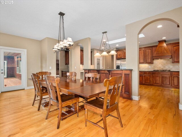 1303 NE 147th Ave, Vancouver, WA 98684 - dining space with light wood-style flooring, arched walkways, baseboards, and recessed lighting