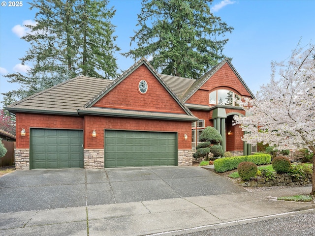 1303 NE 147th Ave, Vancouver, WA 98684 - view of front of house featuring an attached garage, concrete driveway, and stone siding