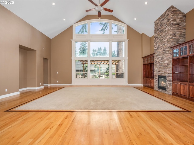 1303 NE 147th Ave, Vancouver, WA 98684 - unfurnished living room with high vaulted ceiling, hardwood / wood-style floors, ceiling fan, a fireplace, and baseboards