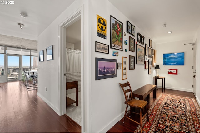 1926 W Burnside St Unit 1401, Portland, OR 97209 - corridor with dark wood-style floors, baseboards, and a wall of windows