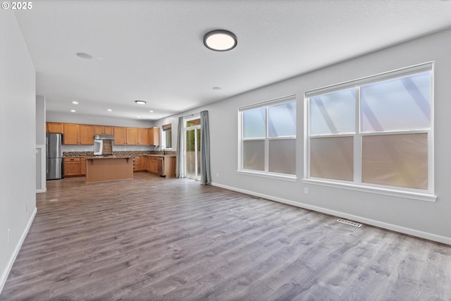 12800 Joys Dr, Oregon City, OR 97045 - kitchen featuring freestanding refrigerator, open floor plan, baseboards, wood finished floors, and recessed lighting