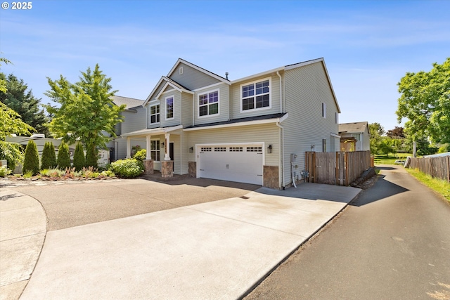 12800 Joys Dr, Oregon City, OR 97045 - view of front of home featuring driveway, an attached garage, and stone siding