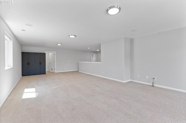 12800 Joys Dr, Oregon City, OR 97045 - unfurnished living room with baseboards, light colored carpet, and recessed lighting