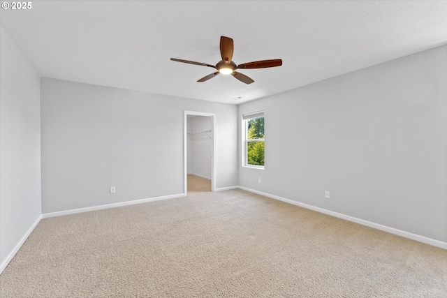 12800 Joys Dr, Oregon City, OR 97045 - unfurnished bedroom with baseboards, carpet floors, a walk in closet, and a ceiling fan
