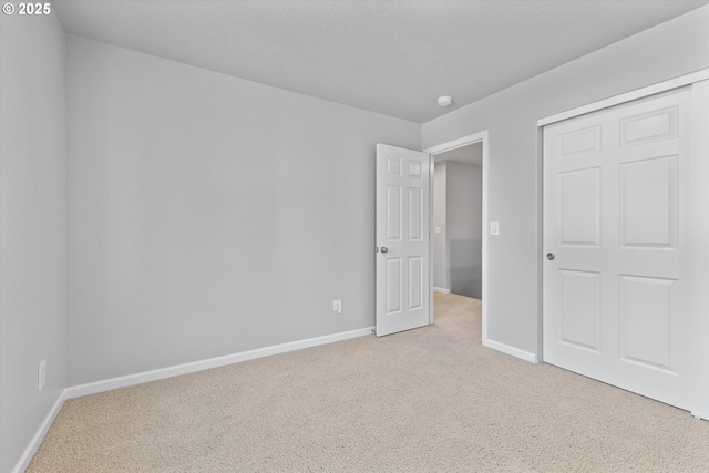 12800 Joys Dr, Oregon City, OR 97045 - unfurnished bedroom featuring light carpet, baseboards, and a closet