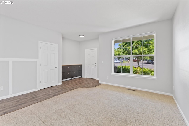 12800 Joys Dr, Oregon City, OR 97045 - empty room featuring baseboards, carpet flooring, and wood finished floors