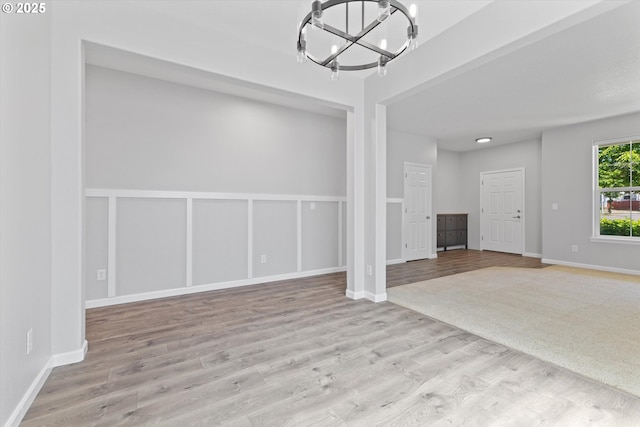 12800 Joys Dr, Oregon City, OR 97045 - spare room featuring a chandelier, wood finished floors, and baseboards