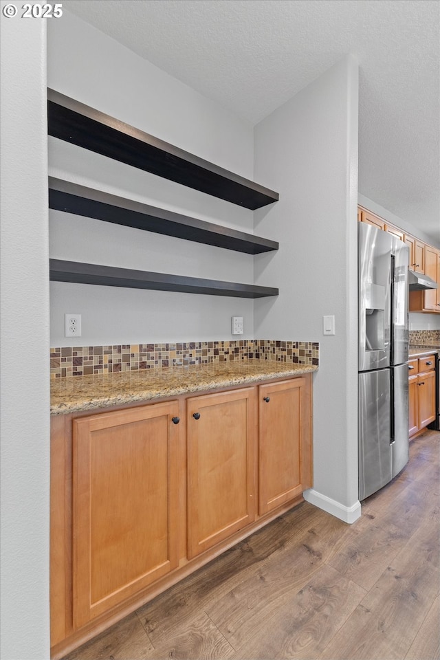 12800 Joys Dr, Oregon City, OR 97045 - bar with stainless steel refrigerator with ice dispenser, light wood finished floors, decorative backsplash, and under cabinet range hood