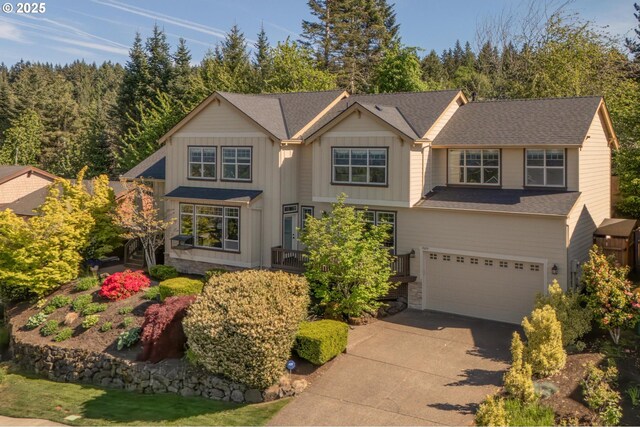 view of front of house with driveway, a garage, and board and batten siding