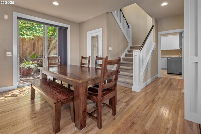 dining room featuring light wood-style flooring, recessed lighting, baseboards, and stairs