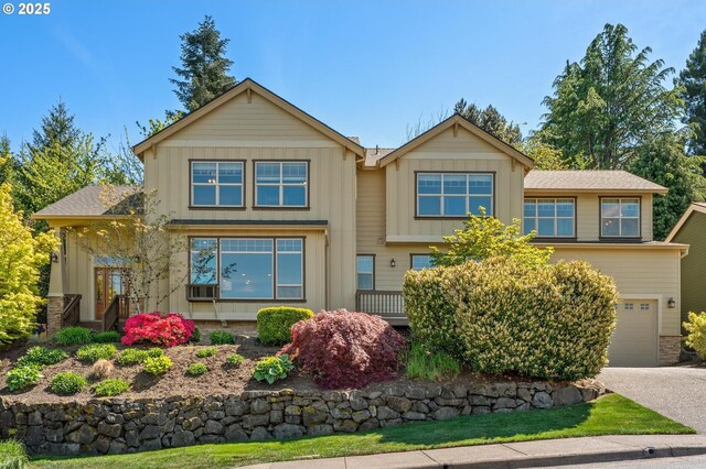 view of front of property with an attached garage, board and batten siding, and driveway