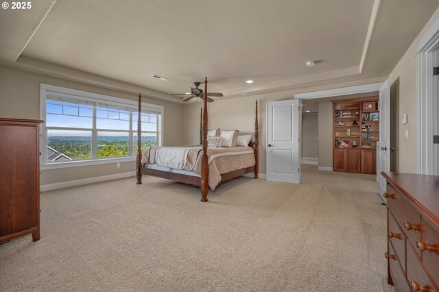 bedroom featuring a raised ceiling, baseboards, light colored carpet, ceiling fan, and recessed lighting